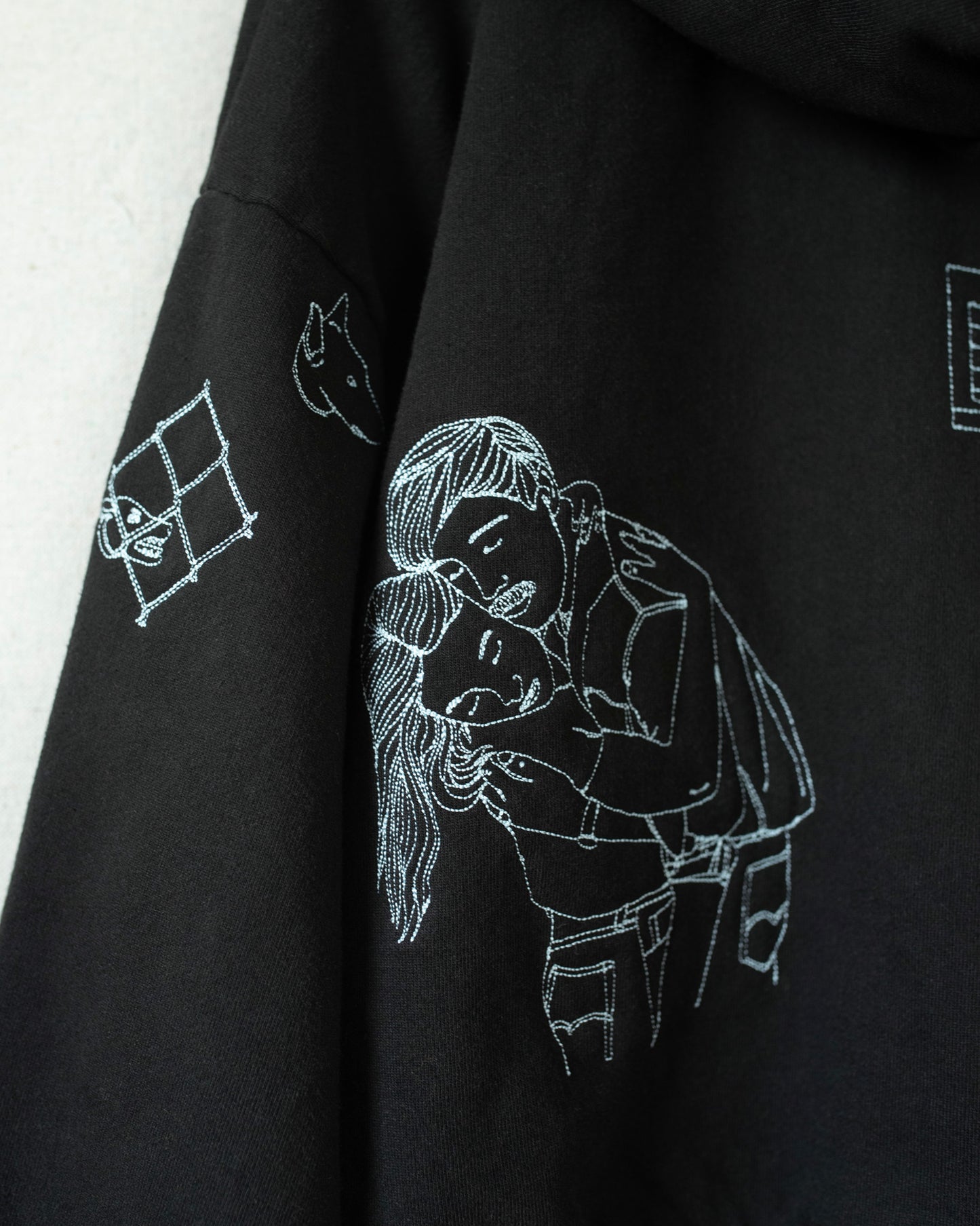 Detailed shot of embroideries on hoodie.