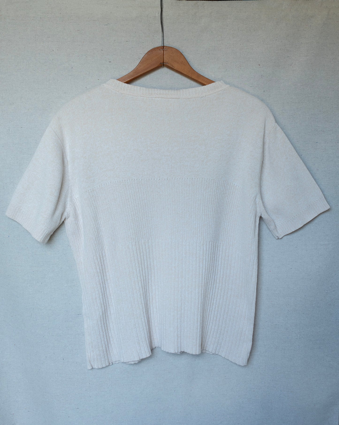 Off white cream knit short sleeve top hanging