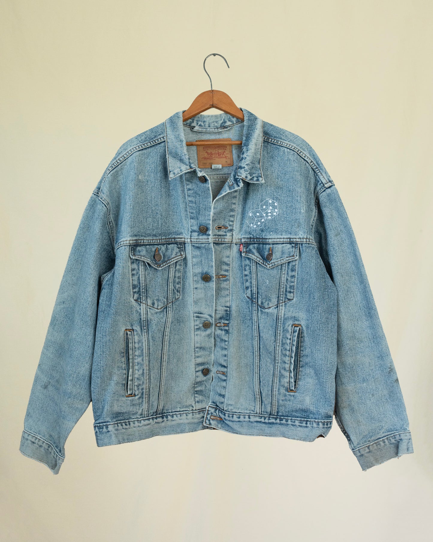 Front of 1990s levis jacket displayed on a hanger.