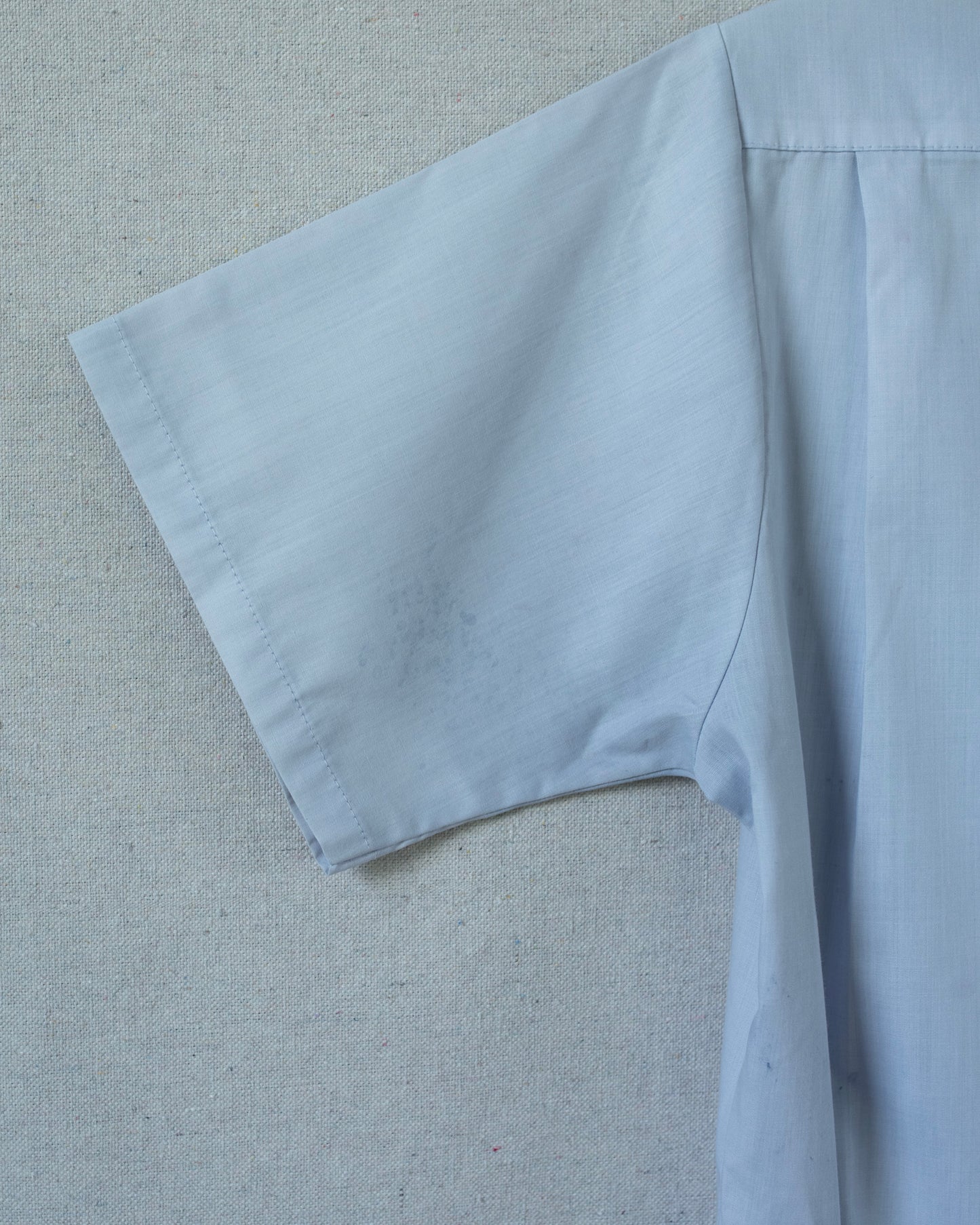 Light blue fabric on a textured gray background