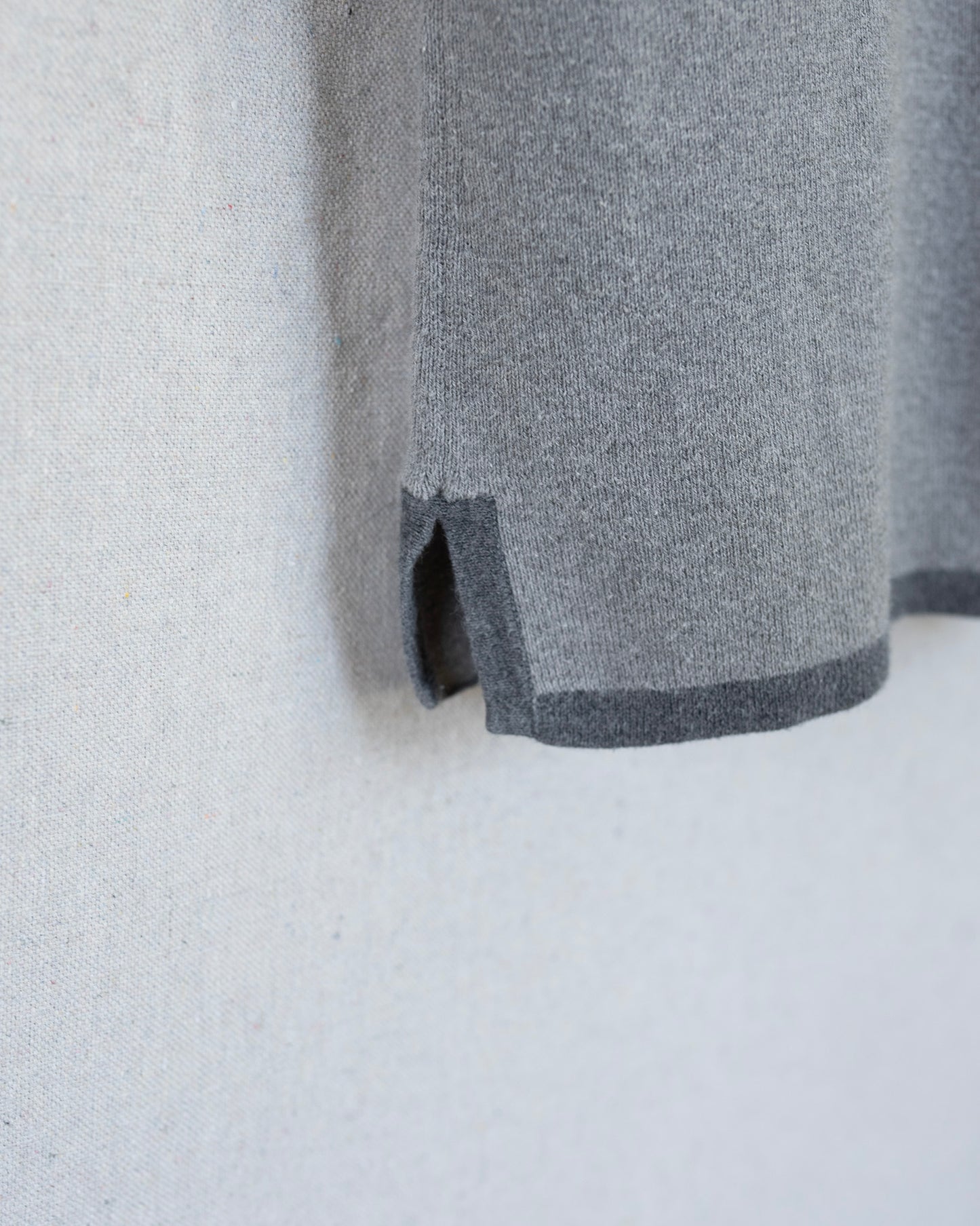Gray fabric with a subtle pattern on a light gray background