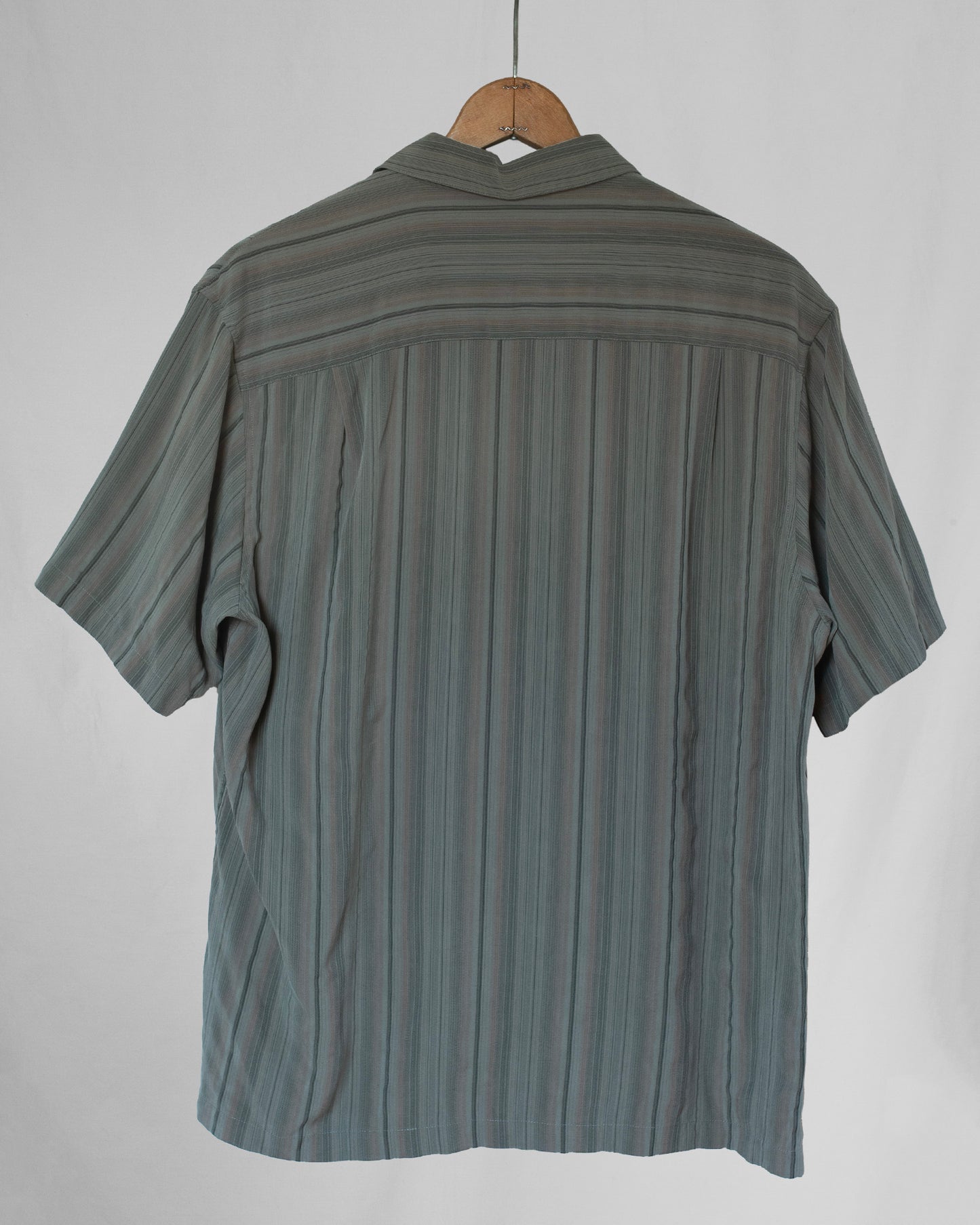 Striped shirt on a hanger against a white background
