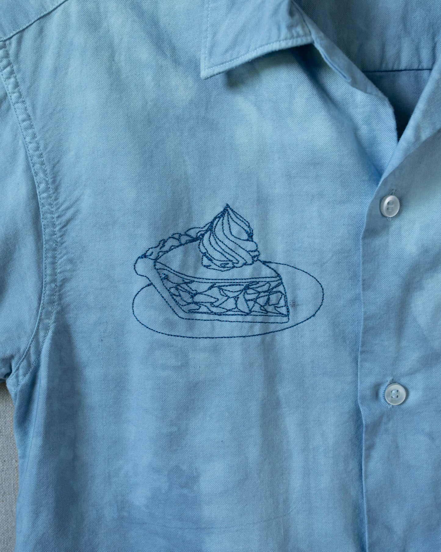 Blue shirt with a pie graphic on a plain background