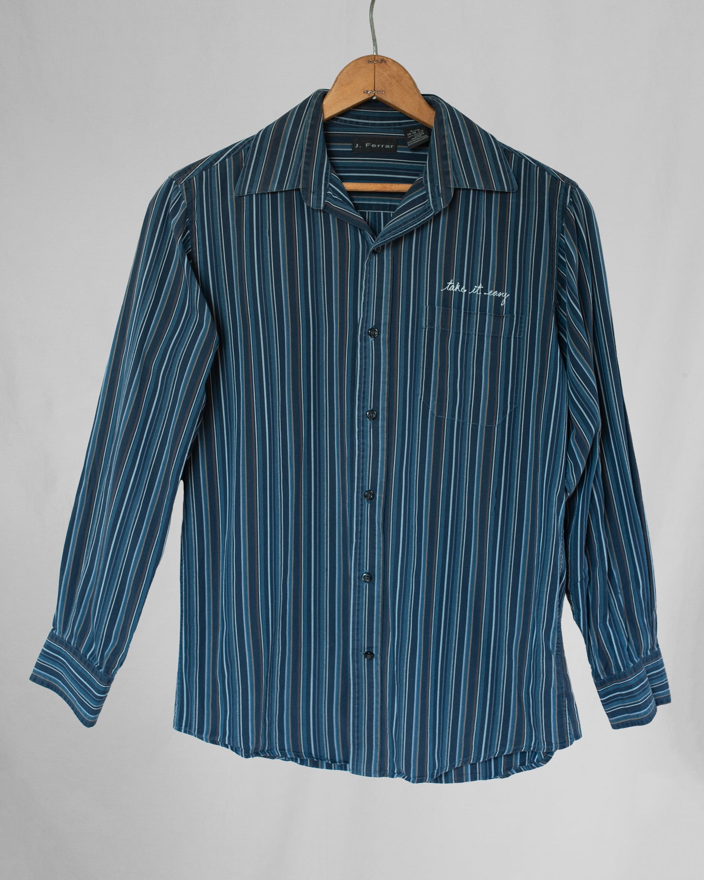 Striped long sleeve button down with take it easy embroidery over pocket.