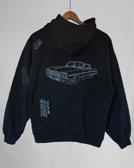 Black hoodie with car graphic and text on a white background