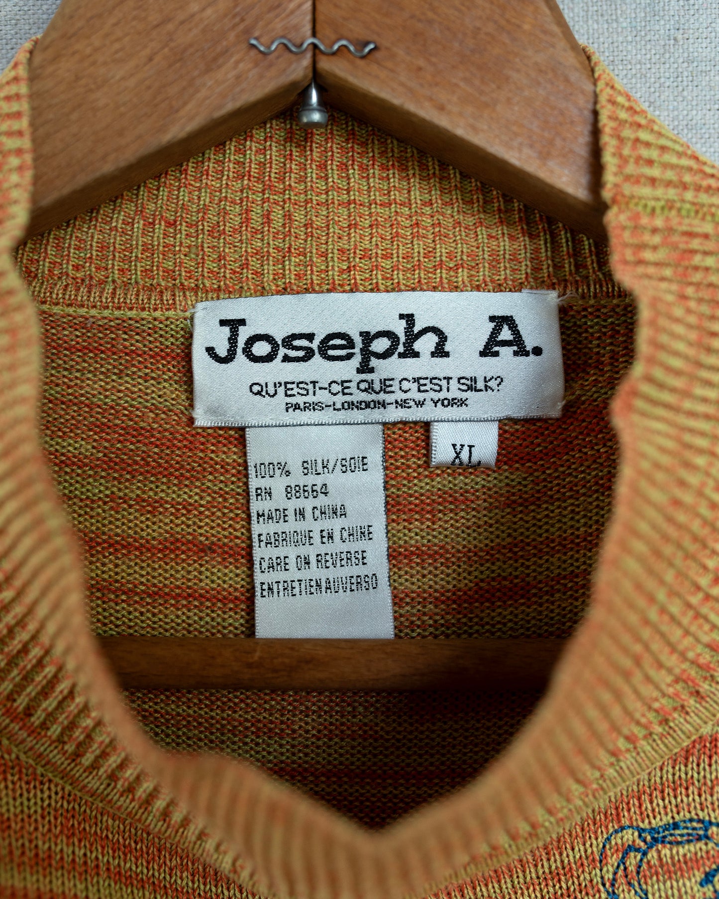 Close-up of a 'Joseph A.' label on a textured fabric background