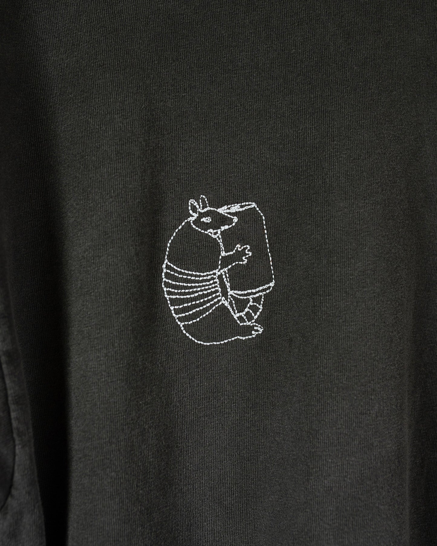 Black t-shirt with an armadillo holding a can embroidery