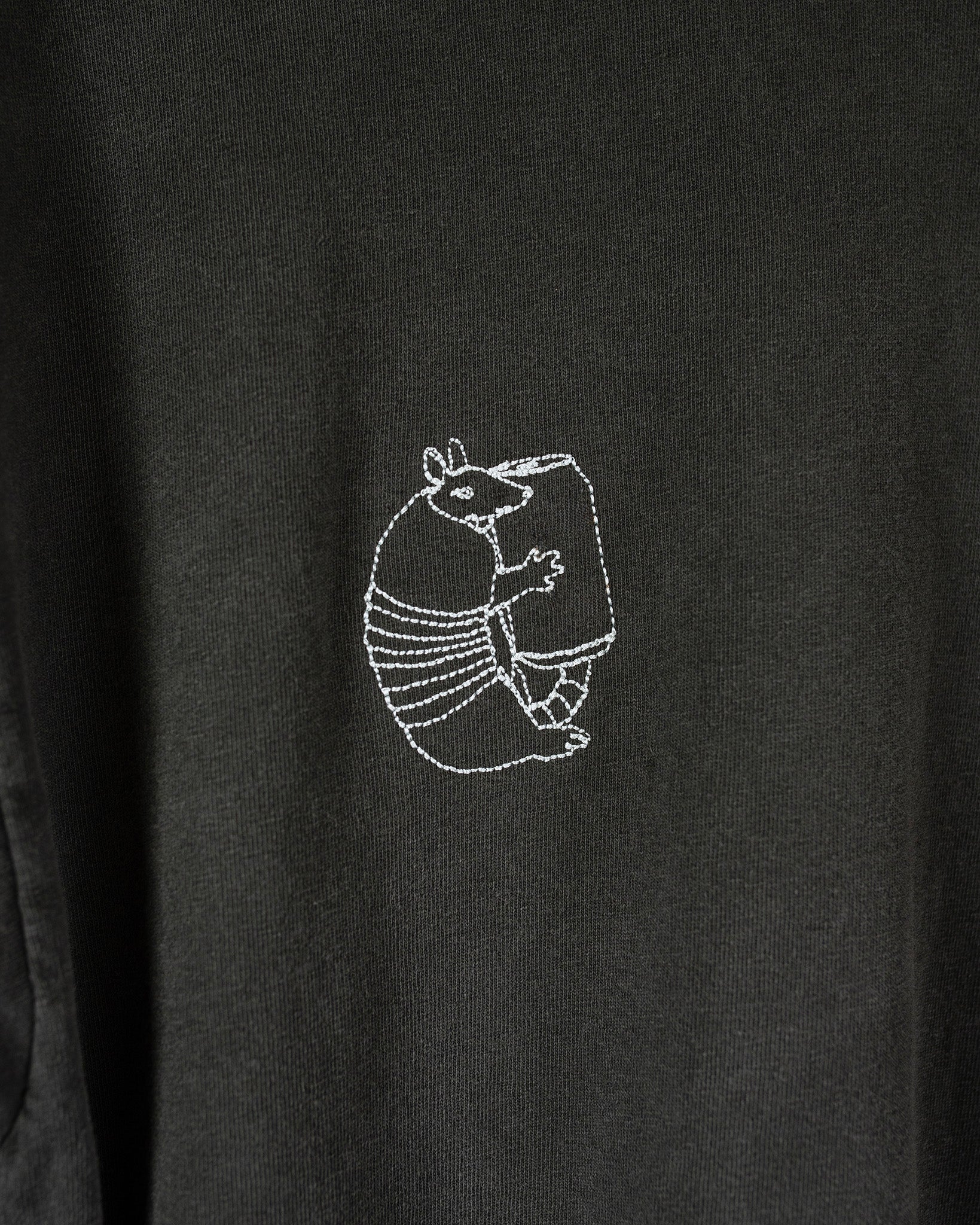 Black t-shirt with an armadillo holding a can embroidery
