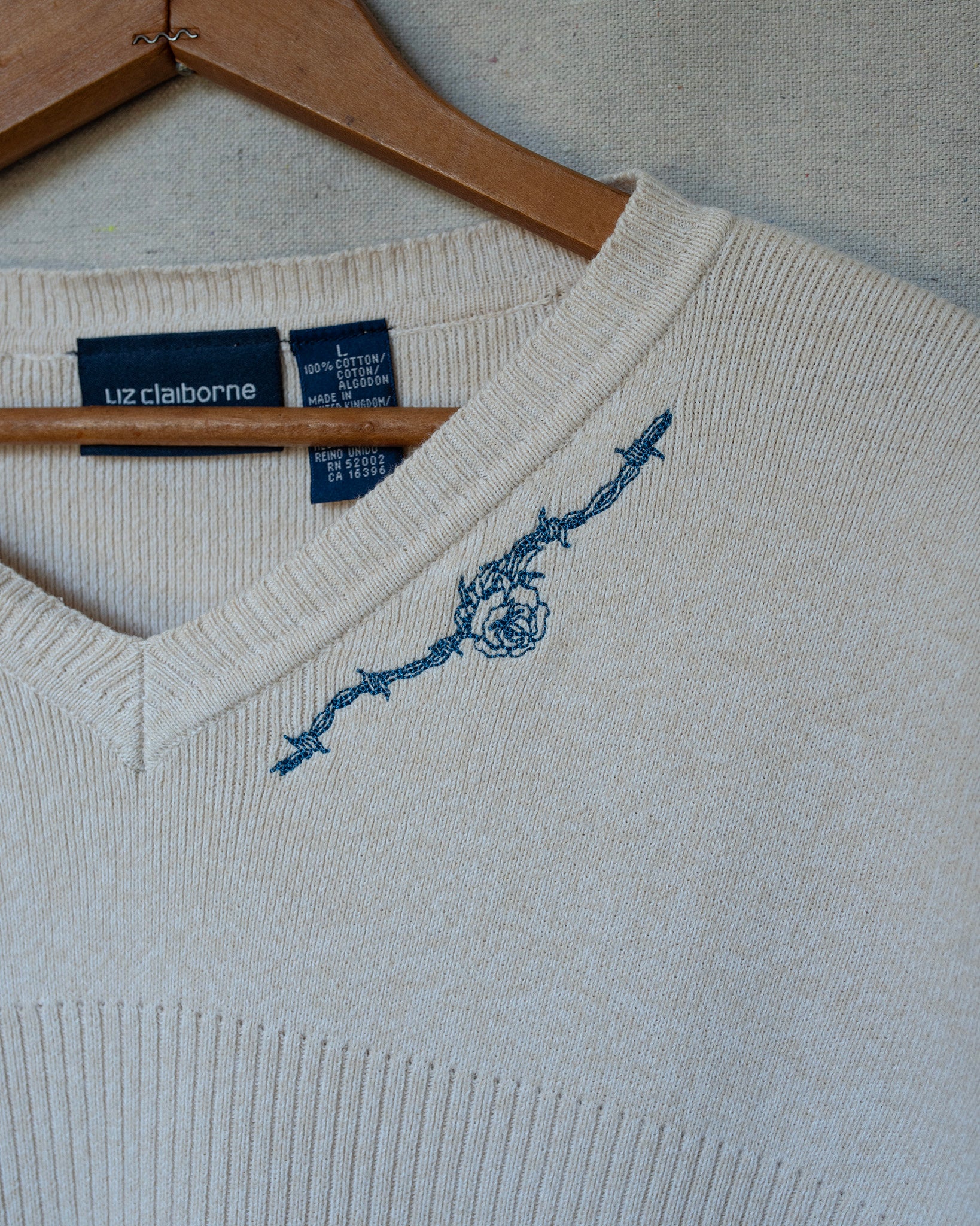 detail of cream knit short sleeve embroidery