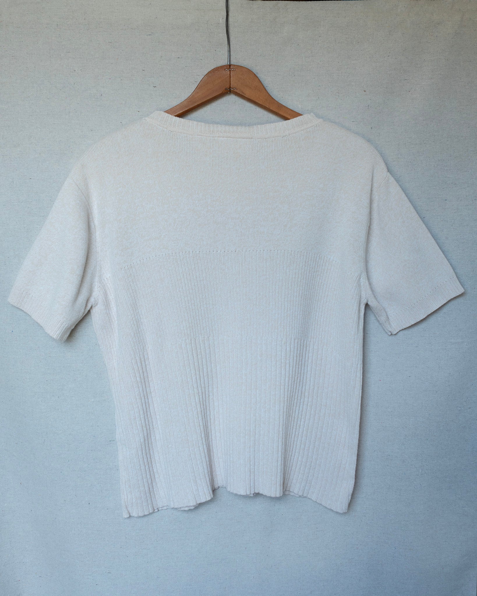Off white cream knit short sleeve top hanging