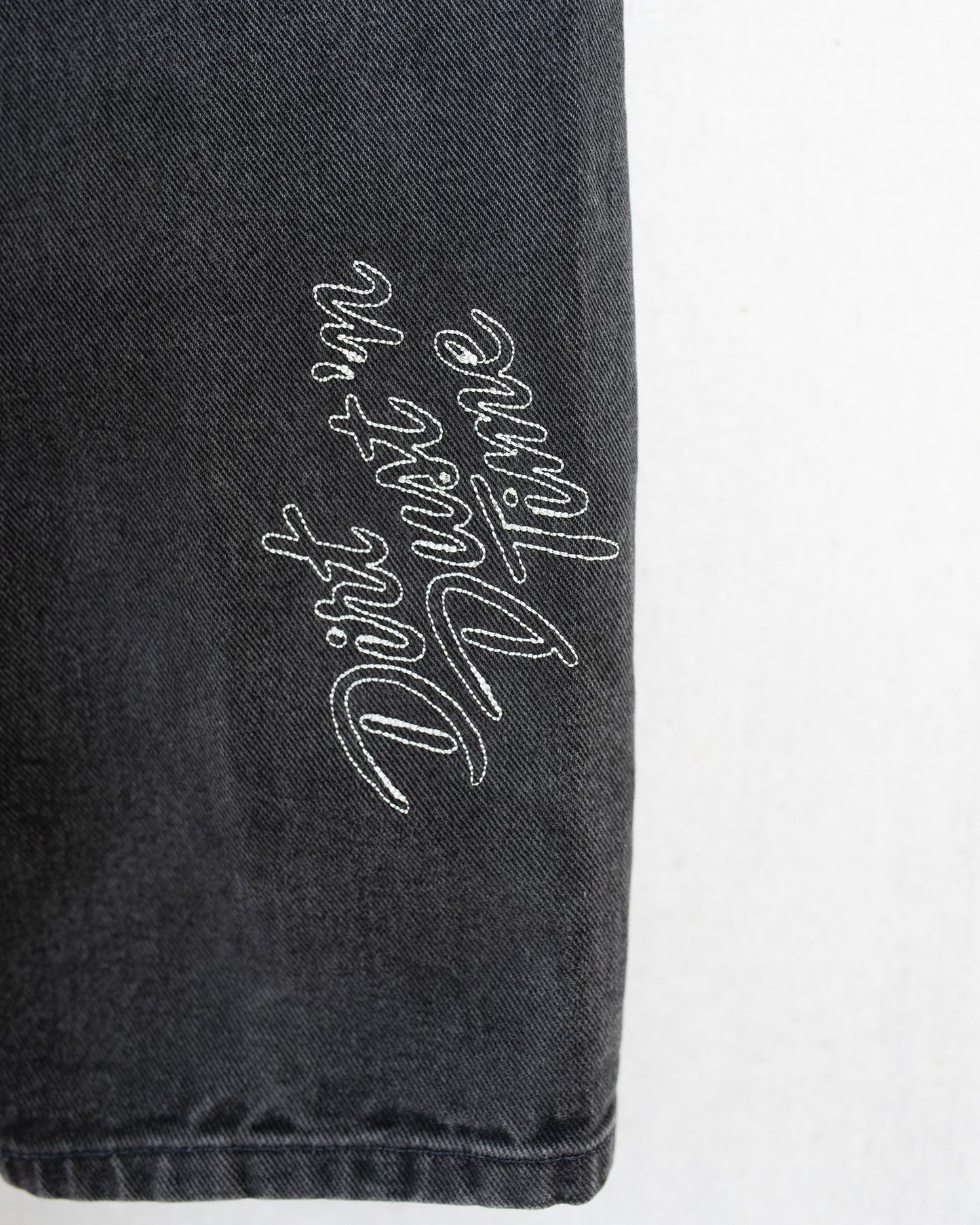 Black denim close up of embroidery.