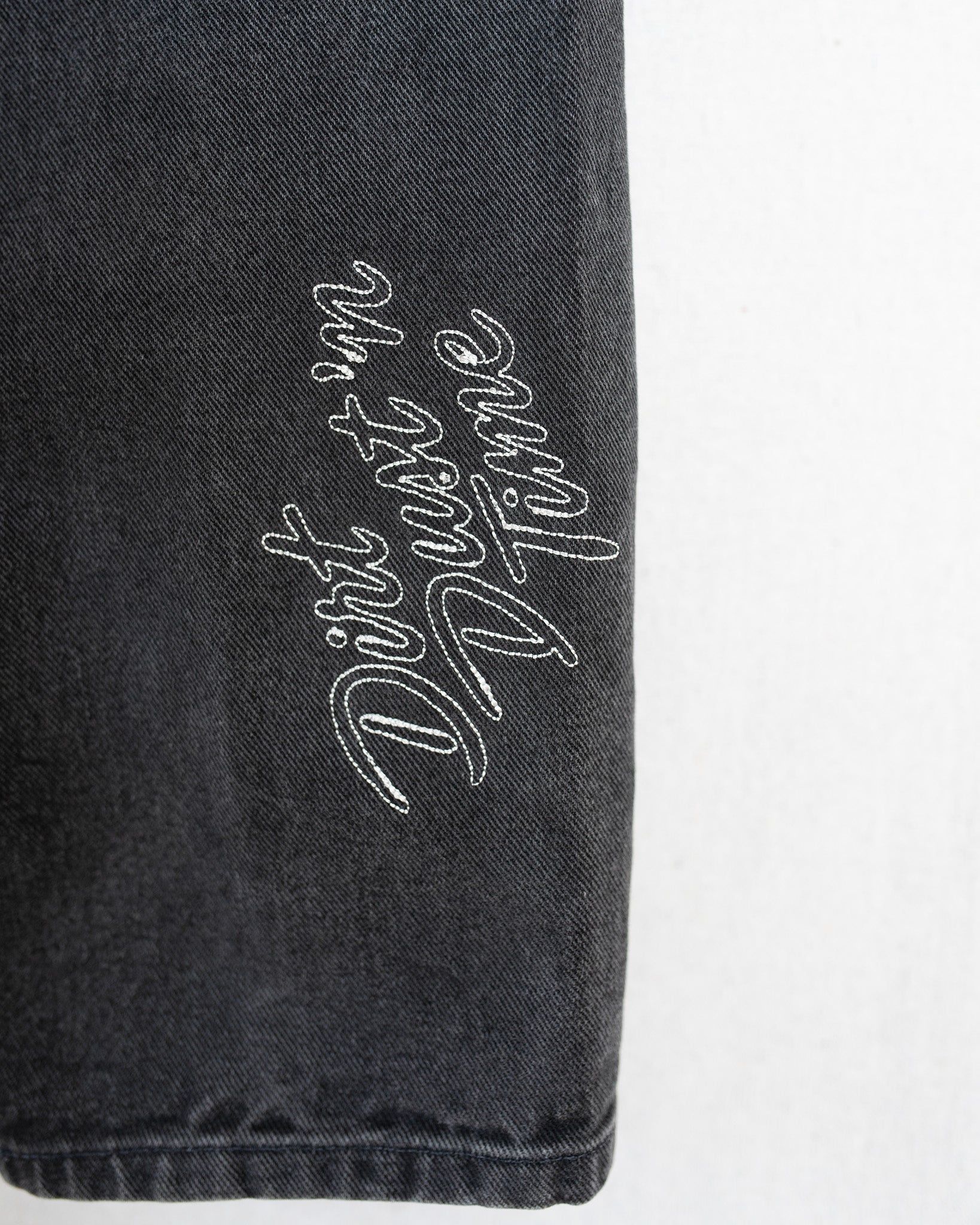 Black denim close up of embroidery.