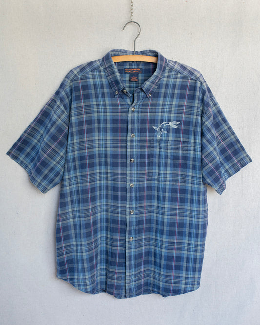 Blue plaid shirt with a koi fish embroidery on a hanger against a white background