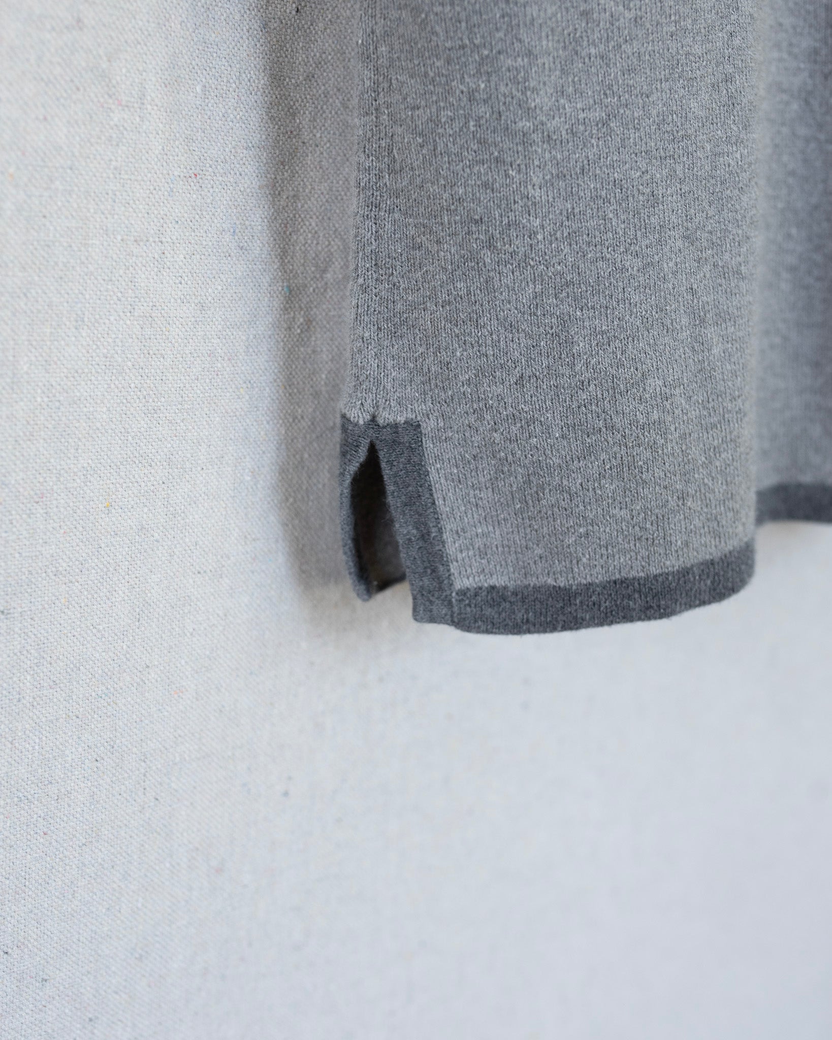 Gray fabric with a subtle pattern on a light gray background