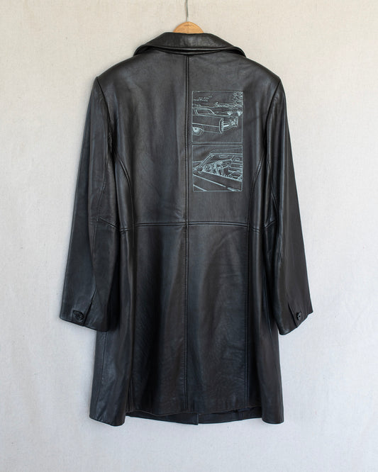 Black leather coat with embroideries on the back, hanging against a white background