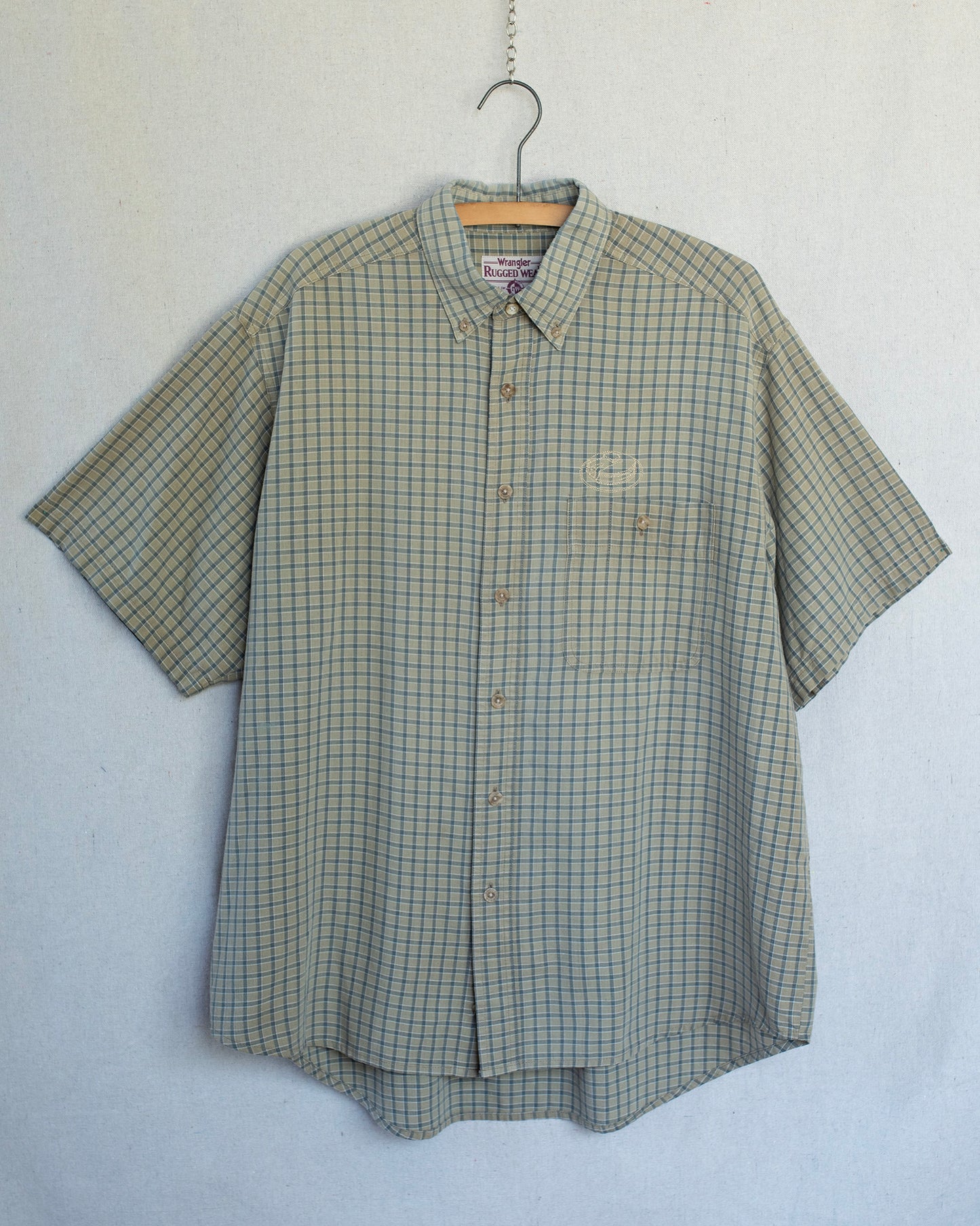 Plaid short sleeve shirt with a pancakes embroidery over chest pocket.