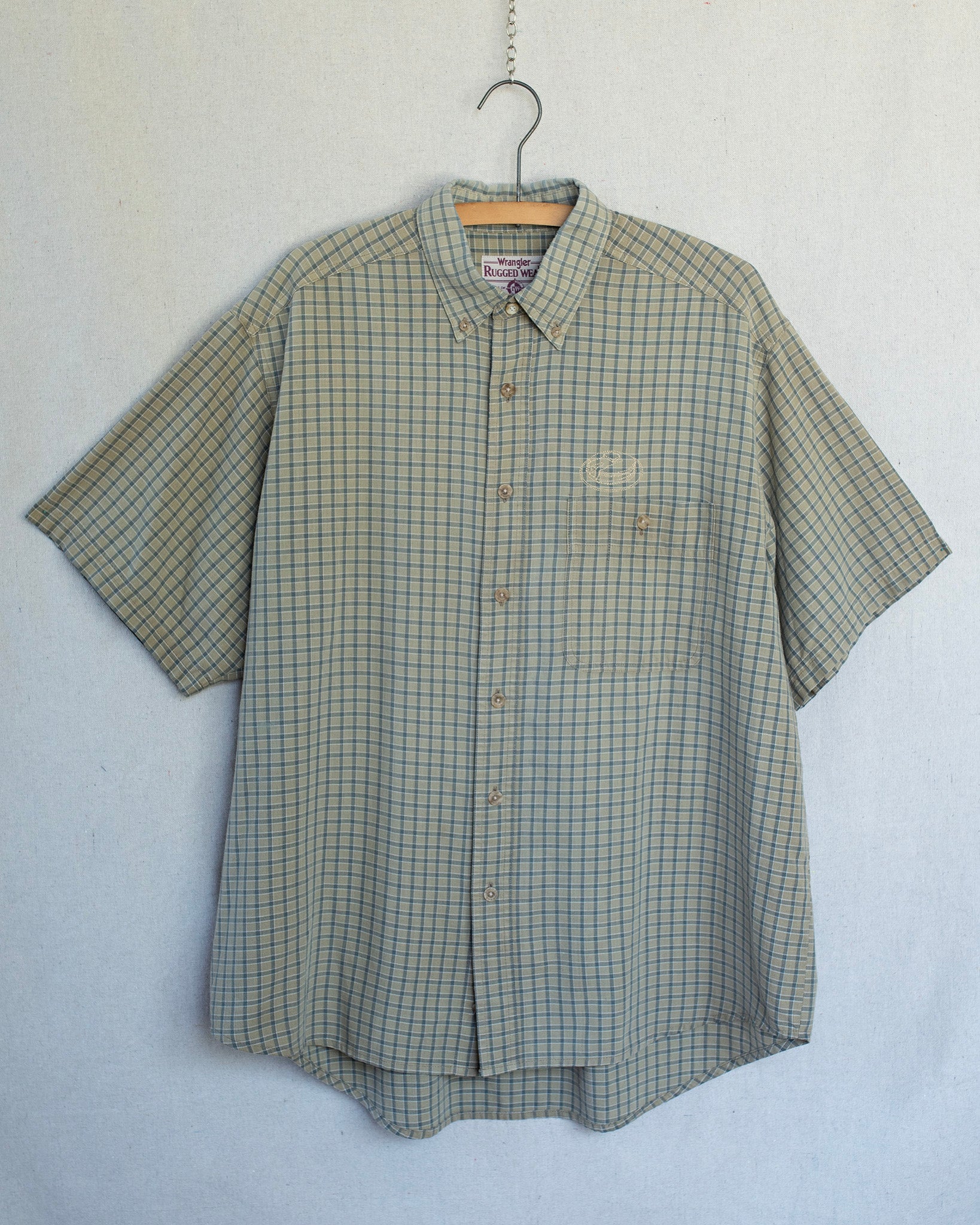 Plaid short sleeve shirt with a pancakes embroidery over chest pocket.