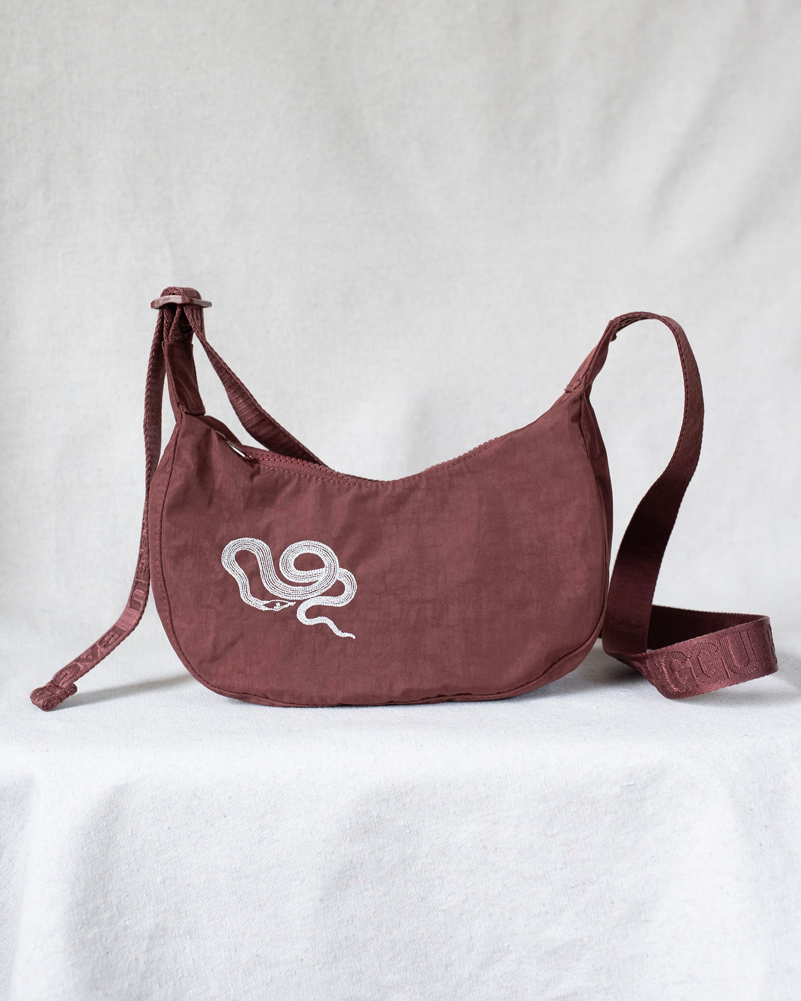 Crossbody bag with snake embroidery.