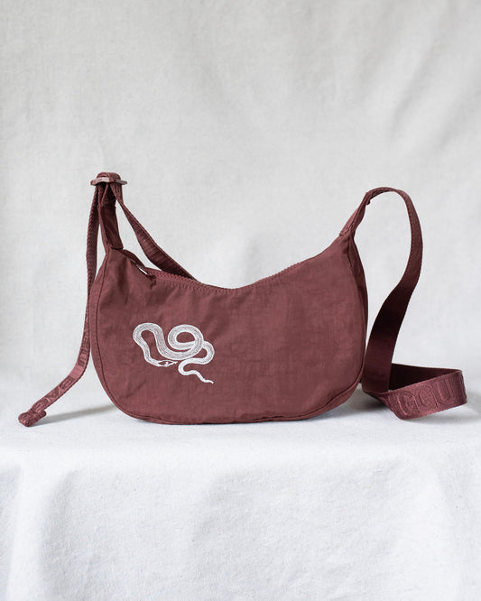 Crossbody bag with snake embroidery.