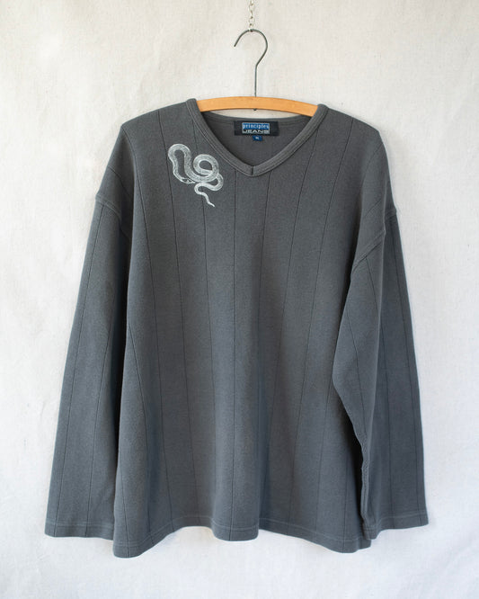 Gray long-sleeve shirt with a snake embroidery on a hanger against a white background
