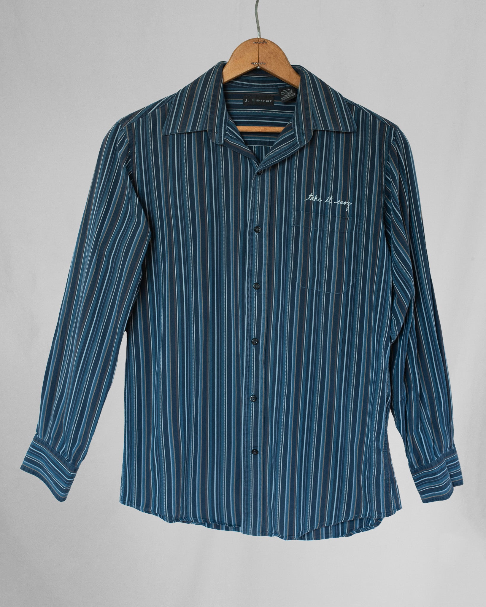 Striped long sleeve button down with take it easy embroidery over pocket.