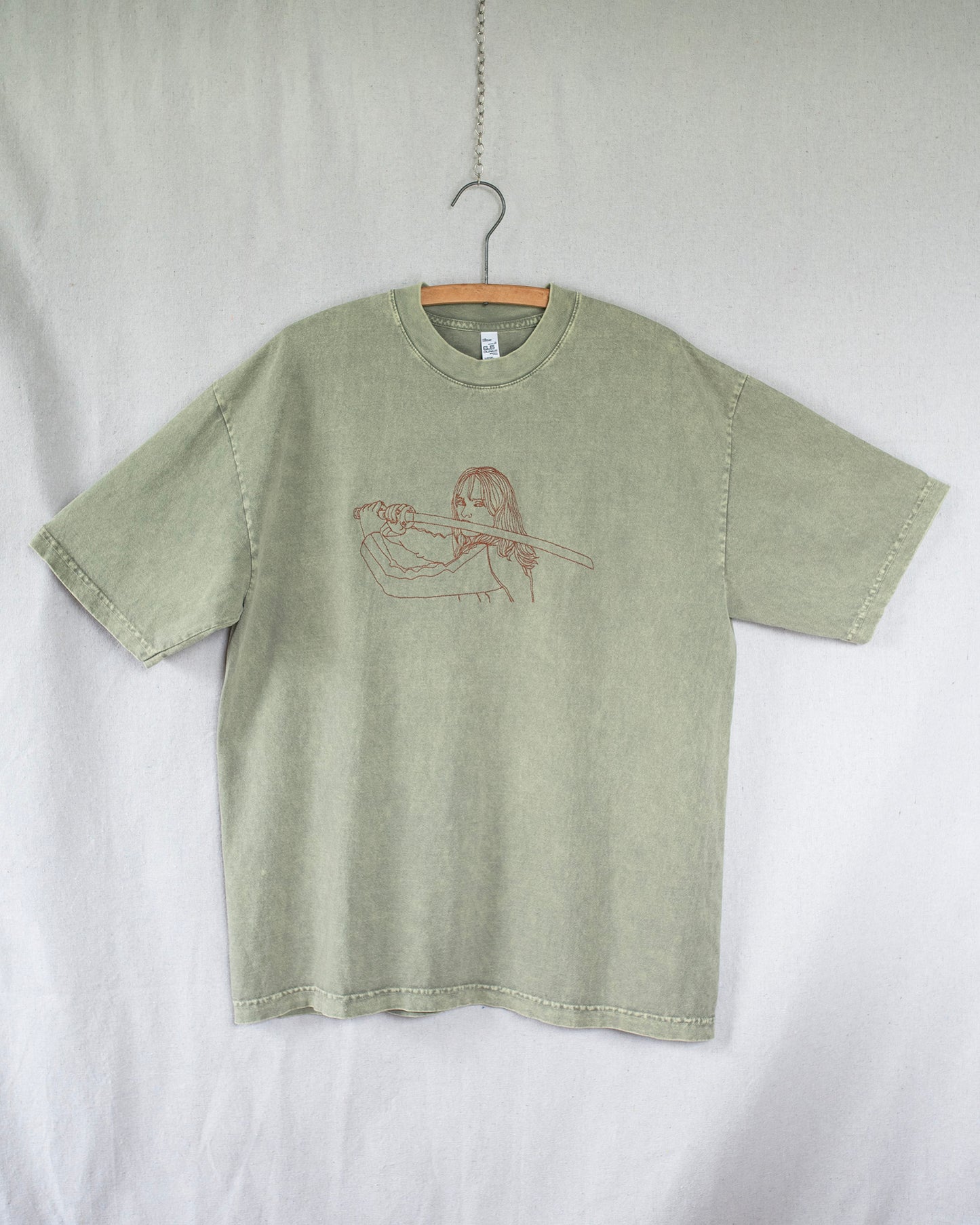 Green t-shirt with a graphic design on a white background