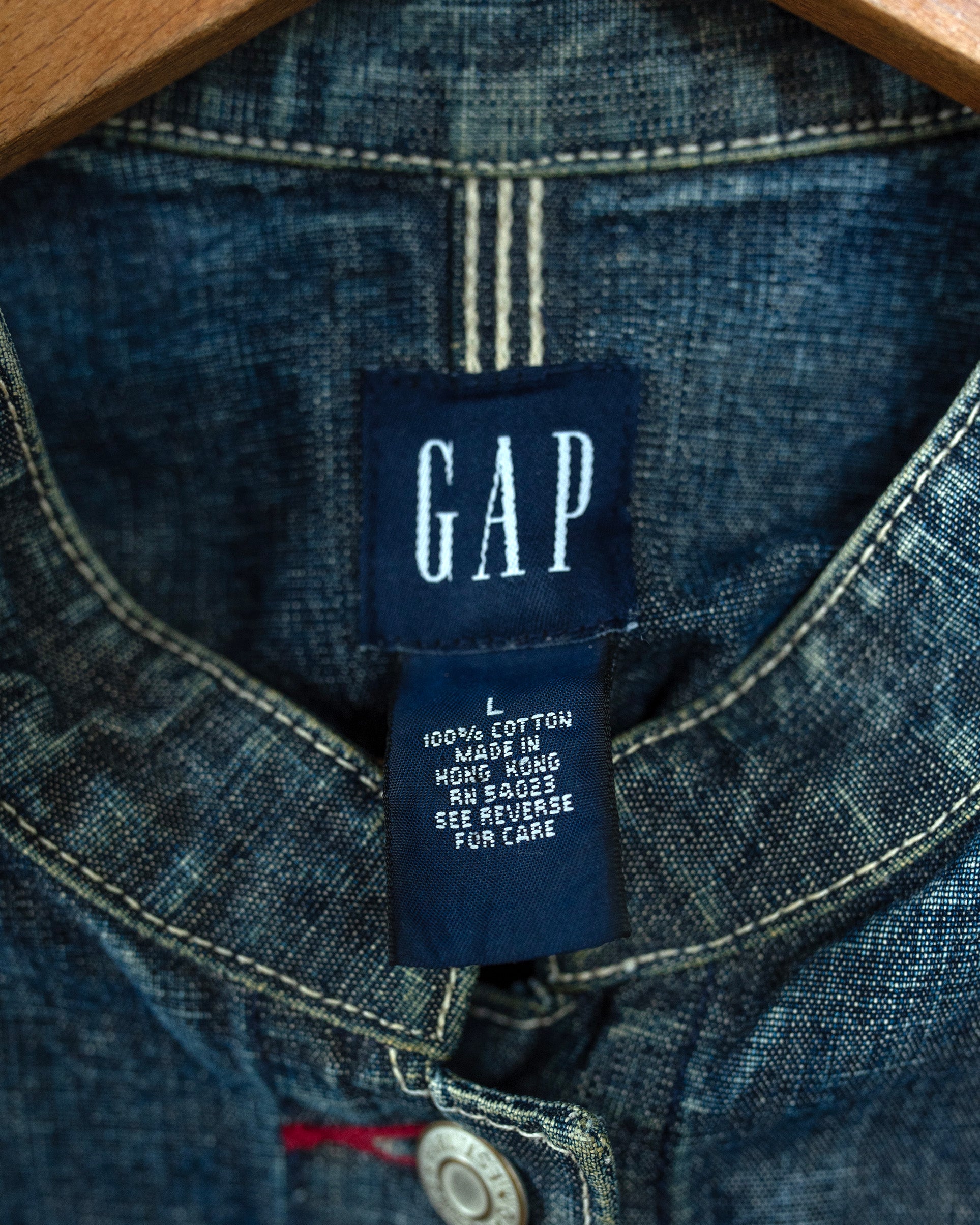 Close-up of a Gap label on a denim garment with visible stitching.